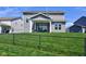 A spacious backyard and covered patio, great for outdoor entertaining and relaxation in your new home at 745 S Summerhaven Ct, New Palestine, IN 46163