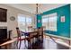 Bright dining room with modern chandelier and turquoise accent wall at 745 S Summerhaven Ct, New Palestine, IN 46163