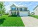 Charming two-story home featuring a well-manicured lawn, inviting entrance, and attached two-car garage at 745 S Summerhaven Ct, New Palestine, IN 46163