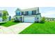 Beautiful two-story home with a two-car garage and a well-kept lawn on a sunny day at 745 S Summerhaven Ct, New Palestine, IN 46163