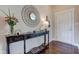 Bright foyer with wood floors, a decorative table with flowers, and a statement mirror at 745 S Summerhaven Ct, New Palestine, IN 46163