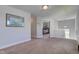Bright hallway with neutral walls and carpet, leading to bedroom with wood-frame bed at 745 S Summerhaven Ct, New Palestine, IN 46163