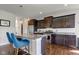 Modern kitchen boasts granite countertops, stainless steel appliances, and a stylish island with bar seating at 745 S Summerhaven Ct, New Palestine, IN 46163