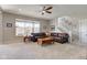 Spacious living room with a ceiling fan, a large window, and a comfortable leather sofa at 745 S Summerhaven Ct, New Palestine, IN 46163