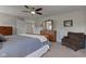 Spacious main bedroom with ceiling fan, dresser, and lounge chair at 745 S Summerhaven Ct, New Palestine, IN 46163