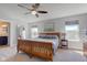 Spacious main bedroom with ceiling fan, two windows, and ensuite bathroom at 745 S Summerhaven Ct, New Palestine, IN 46163