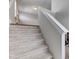 Carpeted staircase with white railing and abundant natural light leads to the upper level at 745 S Summerhaven Ct, New Palestine, IN 46163
