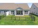 Fenced backyard featuring a covered patio with seating, ideal for outdoor relaxation at 75 Hovden Dr, Cicero, IN 46034
