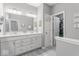 Bathroom featuring double sinks, modern fixtures, and a large walk-in closet at 75 Hovden Dr, Cicero, IN 46034