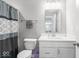 Well-lit bathroom with a modern vanity, white cabinets, and shower-tub combination at 75 Hovden Dr, Cicero, IN 46034