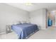 Neutral bedroom with a blue bedspread, ceiling fan, and ensuite bathroom at 75 Hovden Dr, Cicero, IN 46034