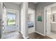 Bright entryway with hardwood floors, leading to a bedroom and bathroom with modern finishes at 75 Hovden Dr, Cicero, IN 46034