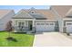 Charming single-story home featuring a two-car garage, covered porch, and well-maintained lawn at 75 Hovden Dr, Cicero, IN 46034