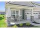 Cozy front porch with stone accents, outdoor seating, and a view of the attached two-car garage at 75 Hovden Dr, Cicero, IN 46034
