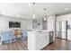 Modern kitchen featuring white cabinets, stainless steel appliances, and a large island with seating at 75 Hovden Dr, Cicero, IN 46034