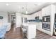 Open-concept kitchen with white cabinets, a large island, and stainless steel appliances at 75 Hovden Dr, Cicero, IN 46034