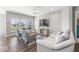 Bright living room with hardwood floors, large windows, a ceiling fan, and comfortable seating at 75 Hovden Dr, Cicero, IN 46034