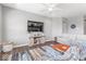 Comfortable living room with hardwood floors, a large TV, stylish seating, and a cozy rug at 75 Hovden Dr, Cicero, IN 46034