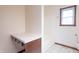 Bright bathroom featuring a tub with white tile flooring, vanity, and a window at 801 Echo Trl, Martinsville, IN 46151