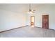 Spacious bedroom with carpet, vaulted ceiling, ceiling fan and wooden door at 801 Echo Trl, Martinsville, IN 46151