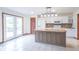 Well-lit kitchen with white cabinets and stainless steel sink island, perfect for entertaining at 801 Echo Trl, Martinsville, IN 46151