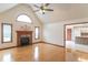 Spacious living room with a fireplace, hardwood flooring, and vaulted ceilings with a large window at 801 Echo Trl, Martinsville, IN 46151