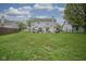 Expansive backyard features lush green grass, patio, hot tub, and outdoor seating area at 8875 White Fir Dr, Indianapolis, IN 46256