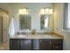 Bright bathroom featuring double sink vanity, granite countertop, decorative mirror, and updated lighting at 8875 White Fir Dr, Indianapolis, IN 46256