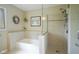 Bathroom with soaking tub and shower with a glass partition and dual shower heads at 8875 White Fir Dr, Indianapolis, IN 46256