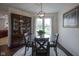 Elegant dining room with a glass-top table, stylish chandelier, and a large china cabinet at 8875 White Fir Dr, Indianapolis, IN 46256