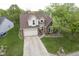Aerial shot showcasing this home's manicured front lawn, brick accents, and inviting two-car garage at 8875 White Fir Dr, Indianapolis, IN 46256