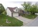Well-maintained two-story home with lush lawn, a two-car garage, and a long driveway at 8875 White Fir Dr, Indianapolis, IN 46256