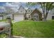 Charming two-story home with a brick facade, manicured lawn, and attached two-car garage at 8875 White Fir Dr, Indianapolis, IN 46256