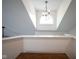 Hallway with an arched window letting in natural light and a modern light fixture at 8875 White Fir Dr, Indianapolis, IN 46256