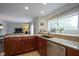 Well-lit kitchen with granite counters and stainless steel appliances flows into living room at 8875 White Fir Dr, Indianapolis, IN 46256