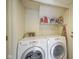 Bright laundry room featuring a side-by-side washer and dryer set and storage at 8875 White Fir Dr, Indianapolis, IN 46256