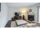 Comfortable living room featuring a fireplace, large TV, and neutral decor at 8875 White Fir Dr, Indianapolis, IN 46256