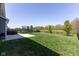 Spacious backyard with a trampoline, patio, professional landscaping, and backing to green space at 900 Parker Ln, Westfield, IN 46074