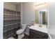 Clean bathroom with a sink vanity, toilet, and patterned shower curtain at 900 Parker Ln, Westfield, IN 46074