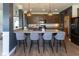 Open-concept kitchen with island seating, stylish pendant lighting, and modern appliances at 900 Parker Ln, Westfield, IN 46074