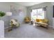 Bright living room with a large world map, chairs with floral upholstery, and lots of natural light at 900 Parker Ln, Westfield, IN 46074