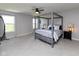 Spacious main bedroom with four-poster bed, ceiling fan, and neutral color palette at 900 Parker Ln, Westfield, IN 46074