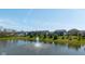 Scenic view of a pond with a fountain surrounded by trees and houses at 900 Parker Ln, Westfield, IN 46074