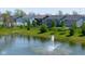 Picturesque view of a pond with a fountain, surrounded by well-maintained lawns and community homes at 900 Parker Ln, Westfield, IN 46074