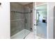 Tiled shower featuring a glass door and a decorative tile border at 900 Parker Ln, Westfield, IN 46074