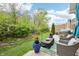 Backyard oasis featuring patio with seating, a manicured lawn, hot tub, and lush landscaping, perfect for entertaining at 9359 Foudray N Cir, Avon, IN 46123