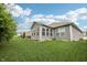 Well-manicured backyard featuring a lush green lawn and enclosed sunroom with large windows at 9359 Foudray N Cir, Avon, IN 46123