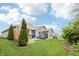 Landscaped backyard with patio, lawn, hot tub, privacy fencing, and mature trees provide serene outdoor space at 9359 Foudray N Cir, Avon, IN 46123
