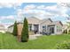 Charming single-story home featuring a stone patio with green lawn and professional landscaping at 9359 Foudray N Cir, Avon, IN 46123