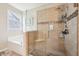 Modern bathroom showcasing a glass enclosed shower with tiled surround, corner seat, and decorative shower niche at 9359 Foudray N Cir, Avon, IN 46123